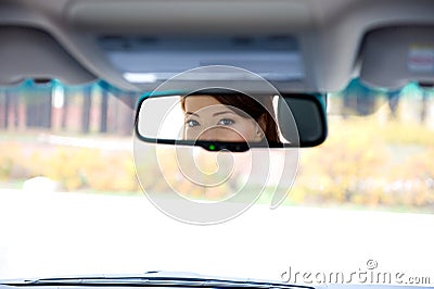 Female eyes in salon a car mirror