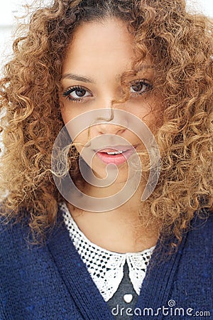 Female fashion model with wind blowing hair over face