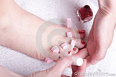 Female feet red polished nails