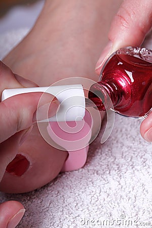 Female feet red polished nails