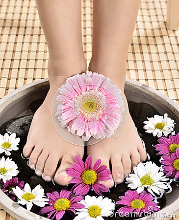 Female feet at spa salon on pedicure procedure