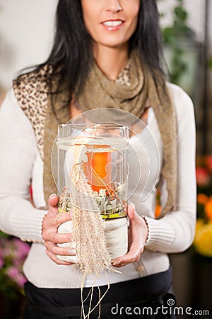 Female florist with candle in flower shop