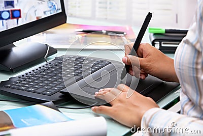 Female graphic designer using tablet pen