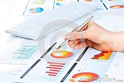 Female hand pointing to the financial growth chart