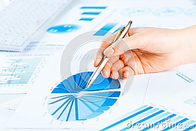 Female hand pointing to the financial growth chart