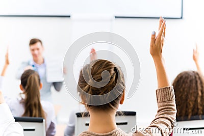 Female hand raised in class