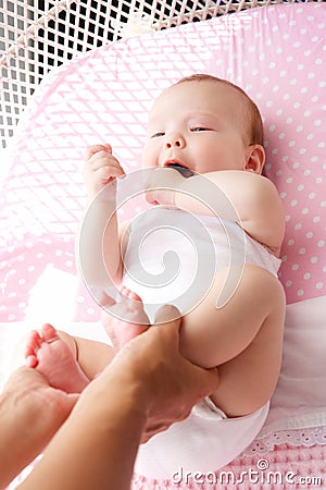 Female hands holding cute baby feet