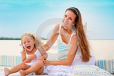 Female and her daughter relax in sea backgraund