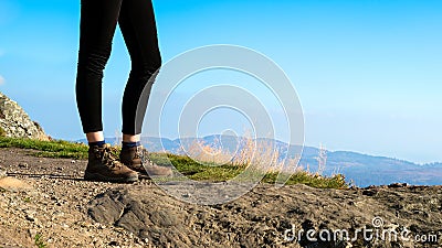 Female hiker on top of the mountain wearing hiking boots
