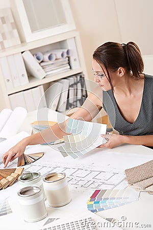 Female interior designer working with color swatch