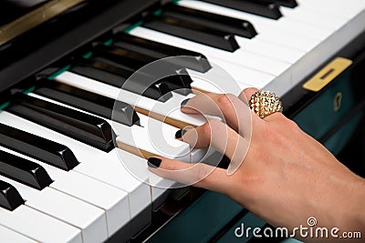 Female lady fingers on the piano keys