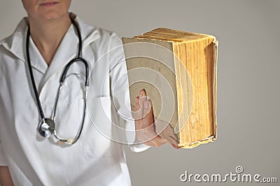 Female medicine student holding a book