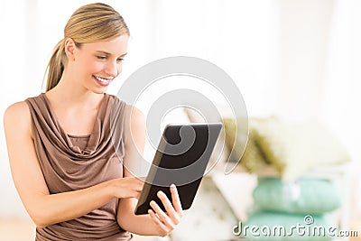 Female Owner Using Digital Tablet In Bedding Store