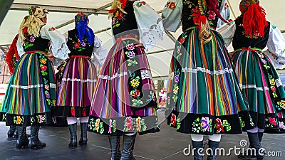 Female polish dancers in traditional folklore costumes on stage