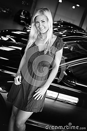 Female posing at line of new cars