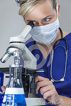 Female Scientist Doctor in Laboratory Using Microscope