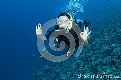 Female scuba diver gives OK sign