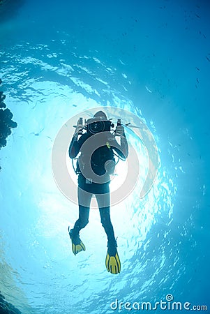 Female scuba diver and underwater video equipment.