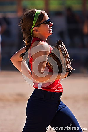 Female softball player jogs off field