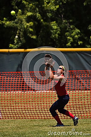 Female softball player prepares to catch ball
