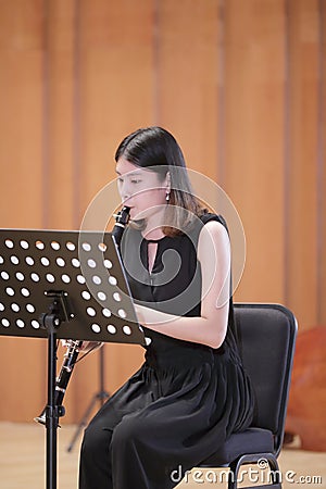 Female student play clarinet