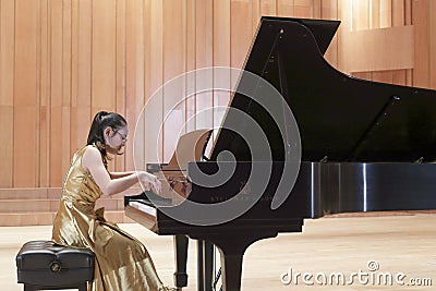 The female student playing piano