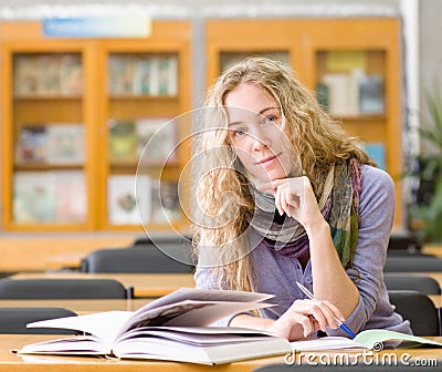 Female student reads the book in library