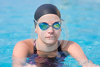 Female swimmer in blue water swimming pool. Sport woman.