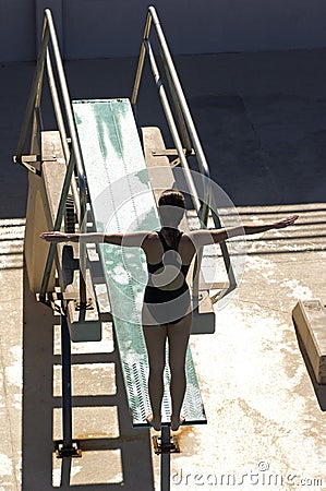 Female Swimmer Diving From The Springboard