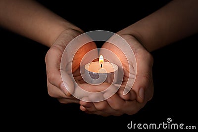 Female teen hands holding burning candle