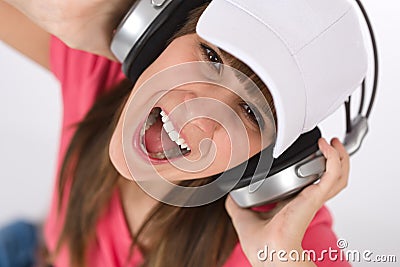 Female teenager singing with headphones