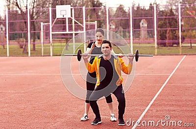 Female trainer with man exercising