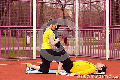 Female trainer with man exercising