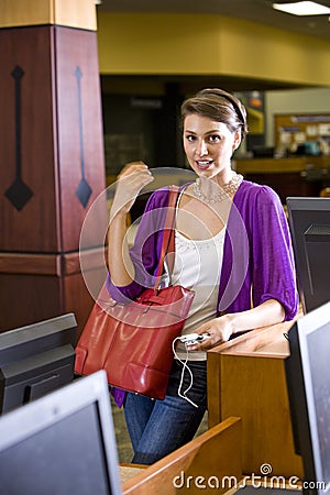 Female university student standing in library