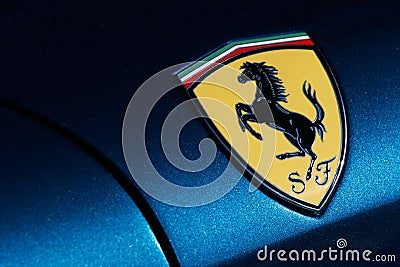 Ferrari logo on blue sport car