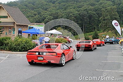 Ferrari and other italian sports cars driving down hill