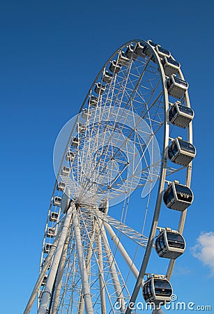 Ferris wheel against bright blue sky