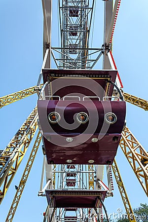 Ferris wheel cabin close-up against blue sky