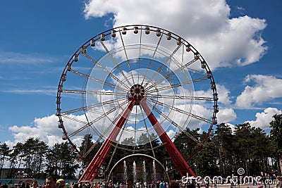 Ferris wheel in Central Park Kharkov against the blue sky with c