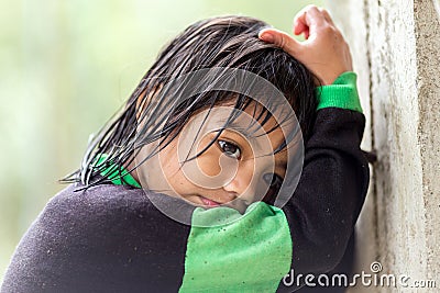 Filipina little girl under the rain