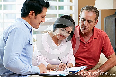 Financial Advisor Talking To Senior Couple At Home