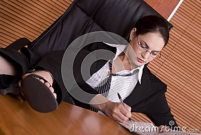 Financial business woman legs on desk