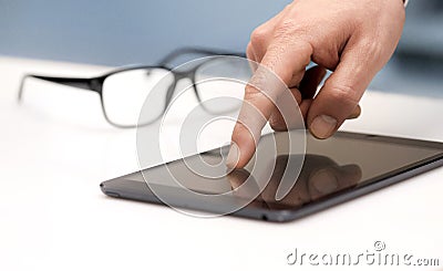 Finger touching a tablet
