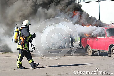 Firefighter and burning car