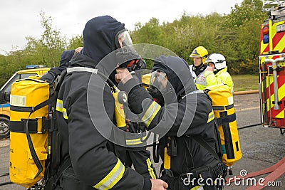 Firefighters check breathing apparatus