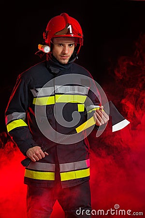 Fireman in smoke holding axe.