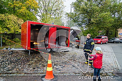 Fireman teaching child to extinguish fire