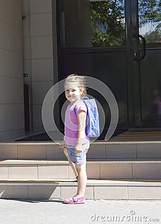 First day of school and happy young girl