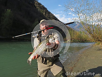 Fisherman holding a trout