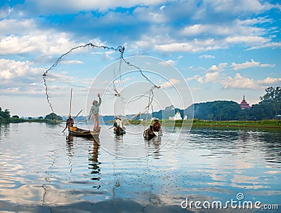 Fishermen catch fish December 3, 2013 in Mandalay